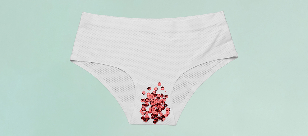 White underwear with red sequins symbolizing menstrual flow on a light green background.