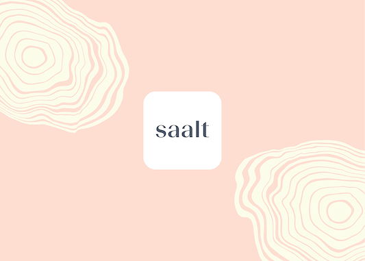 Pink background with abstract contour shapes framing a centered white square logo reading "saalt"