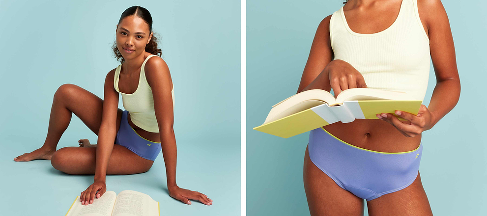 Model in pastel underwear and tank top posing and reading a book against a light blue background.
