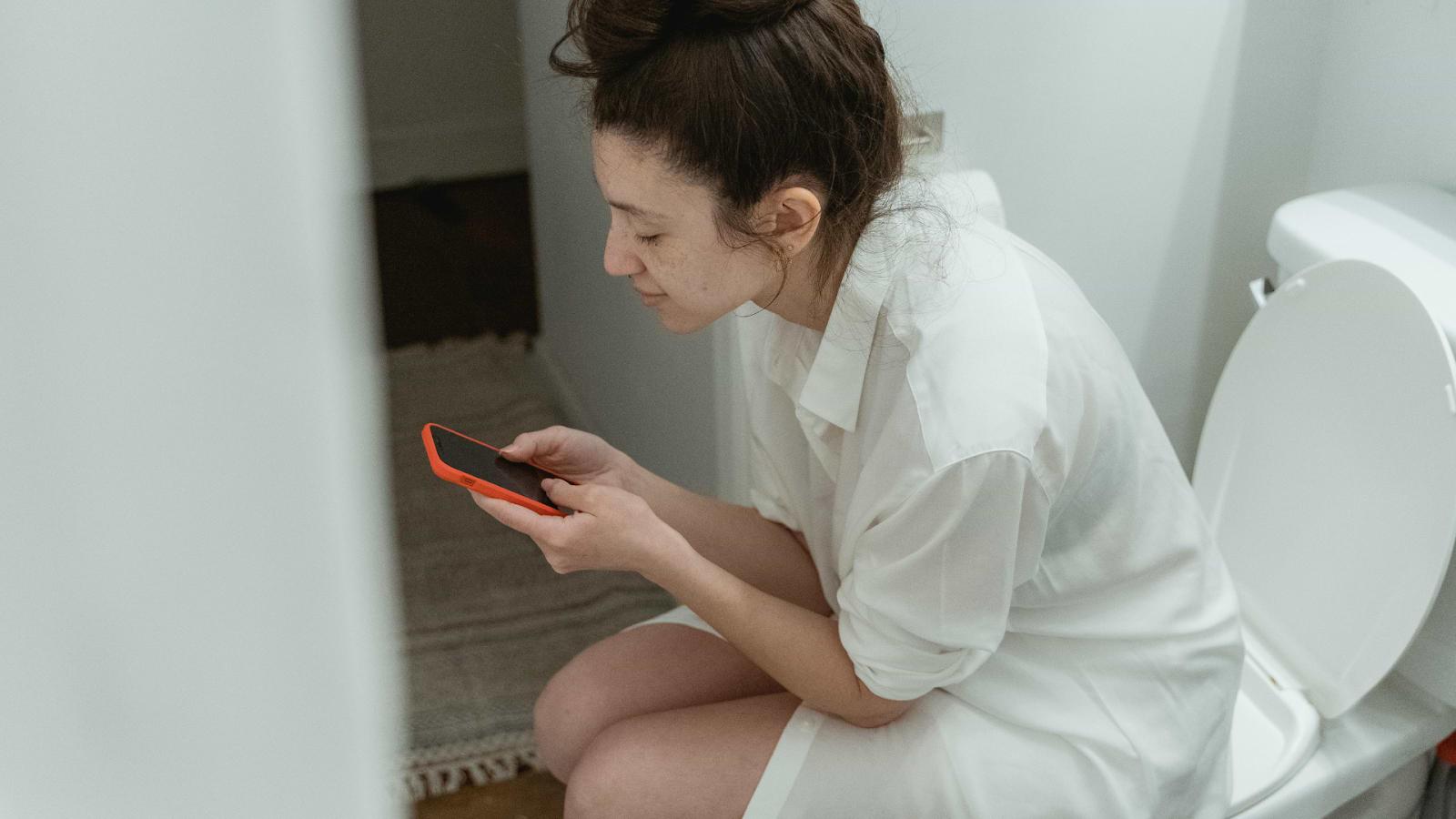 Woman On Toilet Looking Up Clear Stretchy Discharge