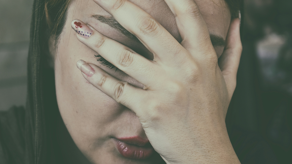 Woman Suffering From Nausea And Covering Her Face