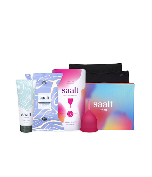 Collection of Saalt products including a tube, packaging, and a pink device on a white background.