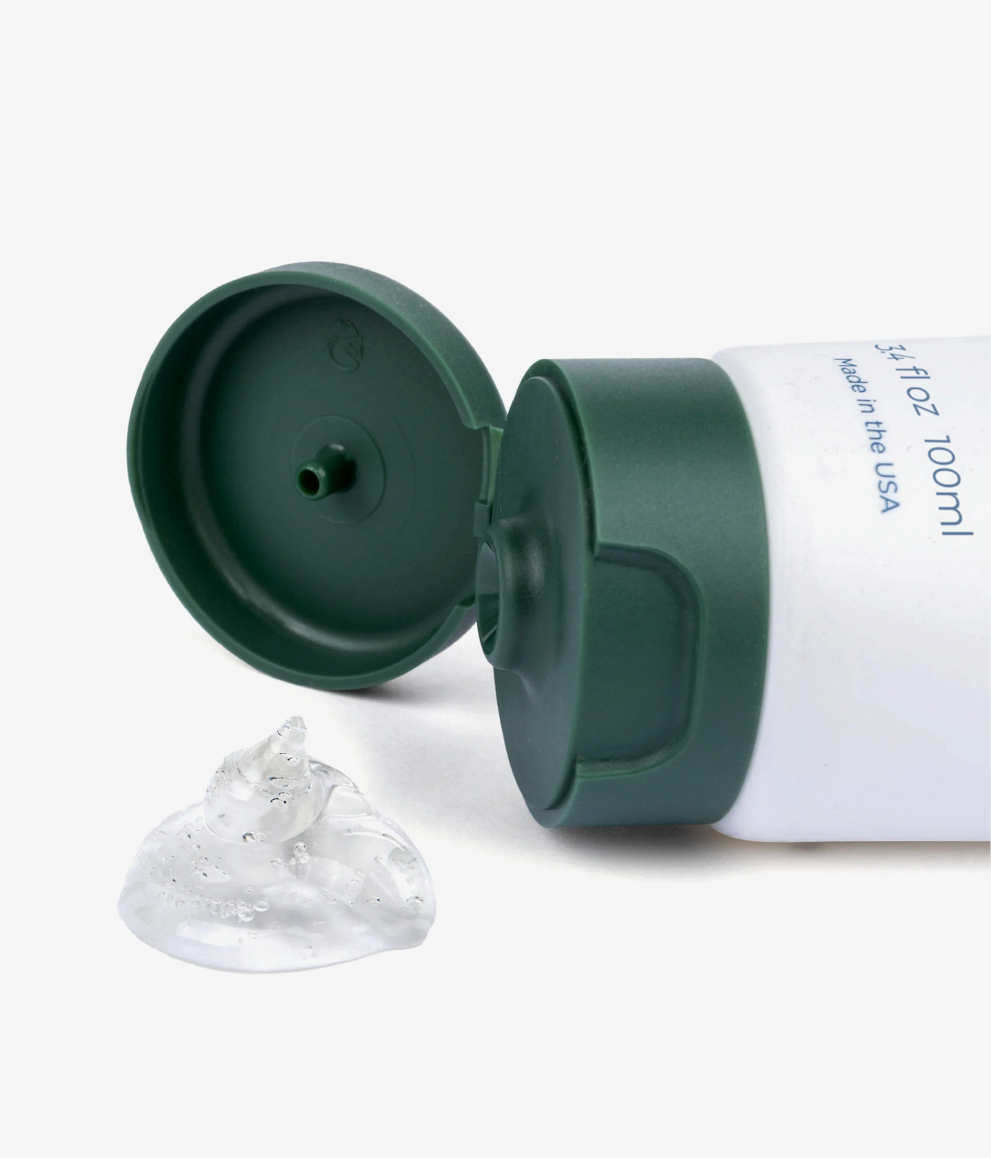 Green and white tube with a clear suction cup on a white background