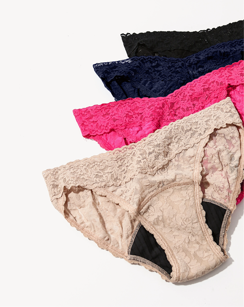 Set of lace underwear in various colors on a white background
