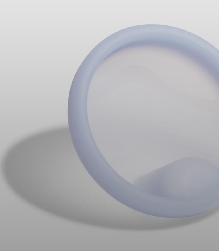 Close-up of a light blue reusable menstrual disc.