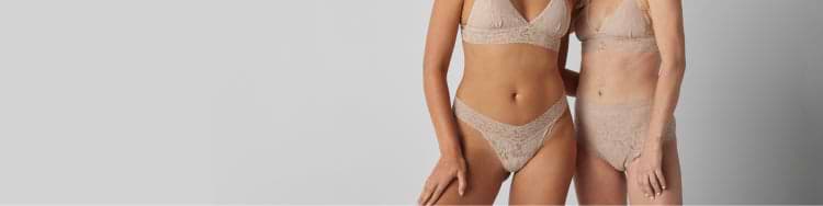 Two models wearing Saalt’s lacy underwear collaboration with Hanky Panky. Color is Chai (nude). Tone is confident and lively.