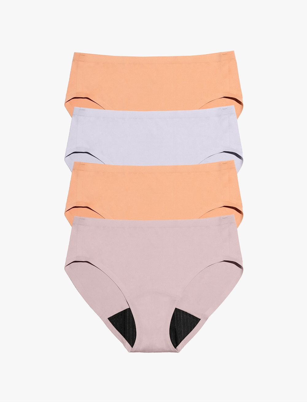 A flatlay of four pairs of Saalt’s leakproof period underwear. Colors are Sunset Mauve, Soft Lavender, and Smooth Terracotta.
