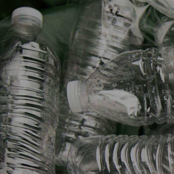 Five water bottles with water drops inside them
