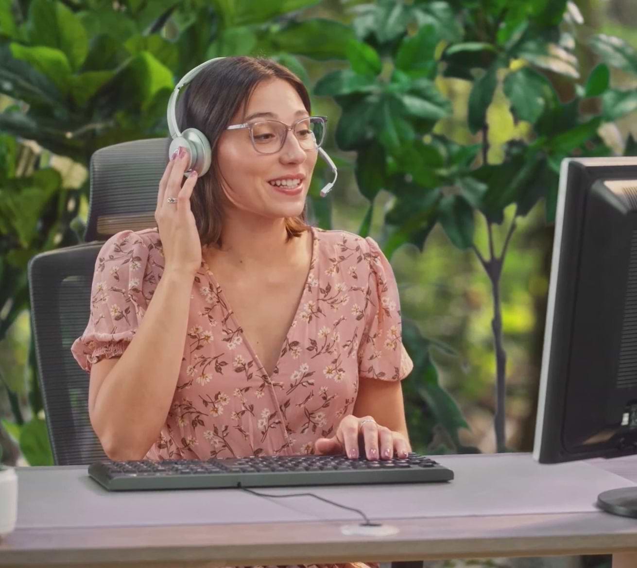 Female on a computer with headphones on