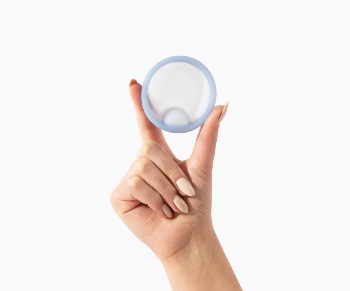 Female hand holding saalt disc upright