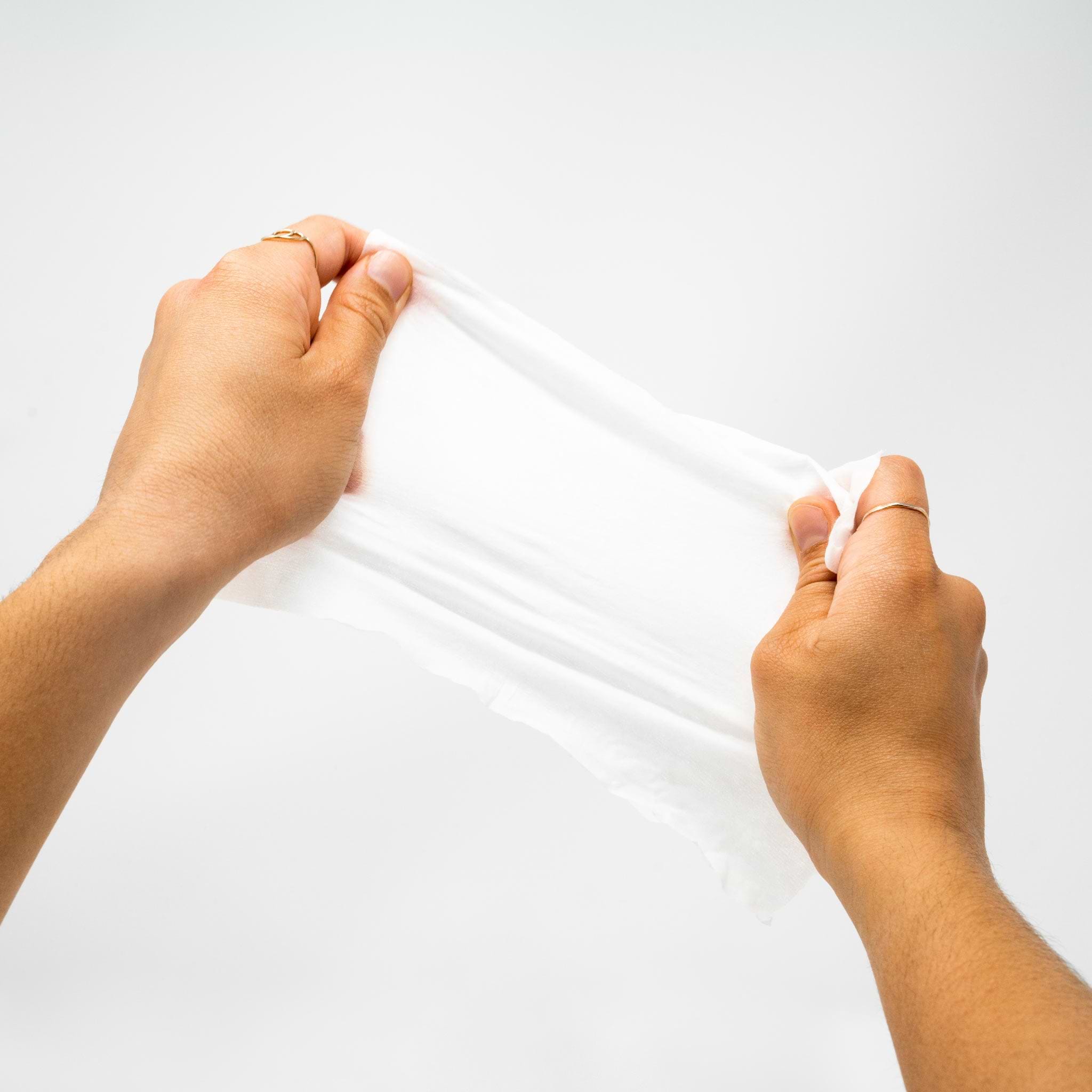 females hands pulling the saalt intimate wipe