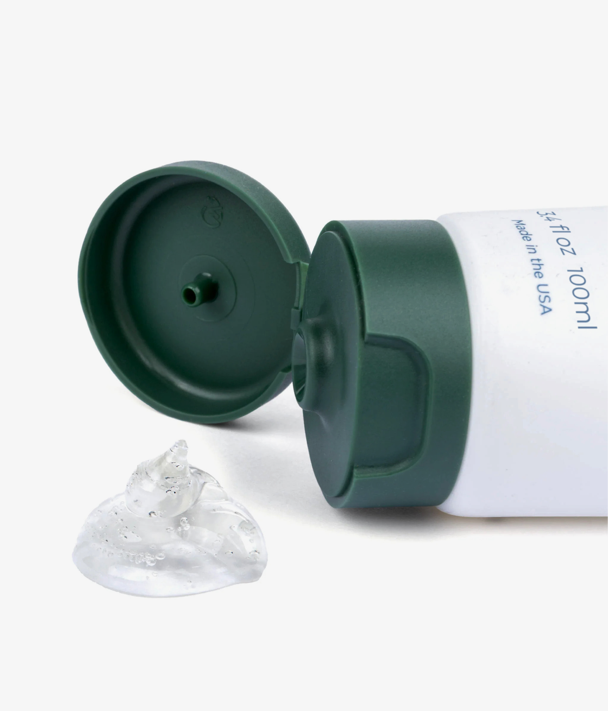 Green and white tube with a clear suction cup on a white background