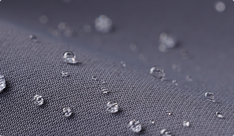 Water droplets on a textured gray surface