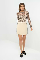 Front view of a skort paired with a cheetah-print long-sleeve top.