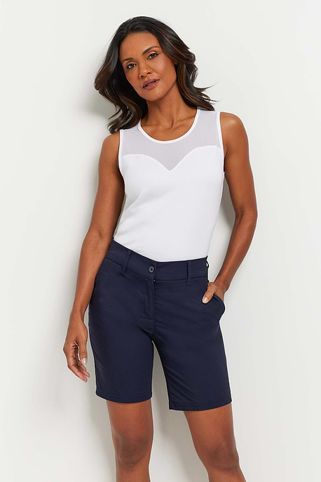 The Best Travel Short. Woman Showing the Front Profile of a Breck Performance Cotton Short in Navy.