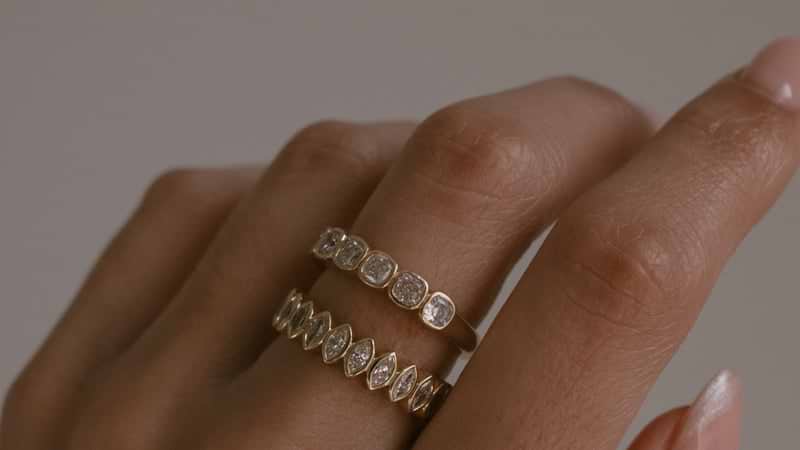 Yellow gold bezel set wedding bands on hand.