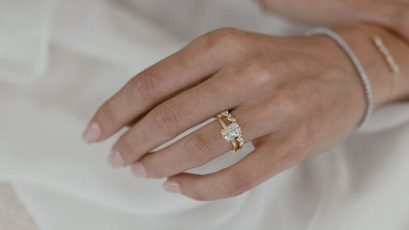 Old mine ring on hand with wedding band