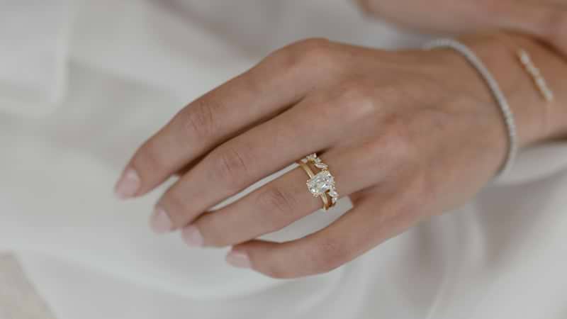 Old mine ring on hand with wedding band