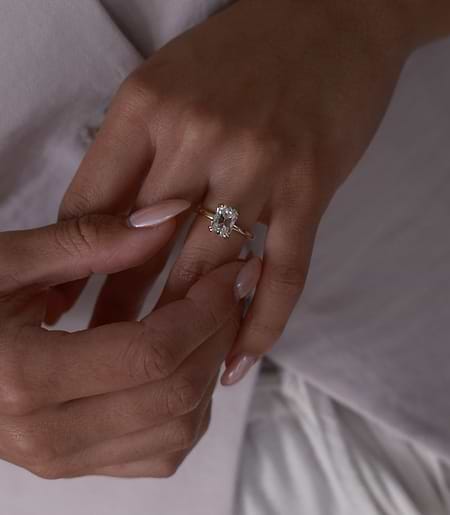 Hands with old mine cut diamond solitaire ring