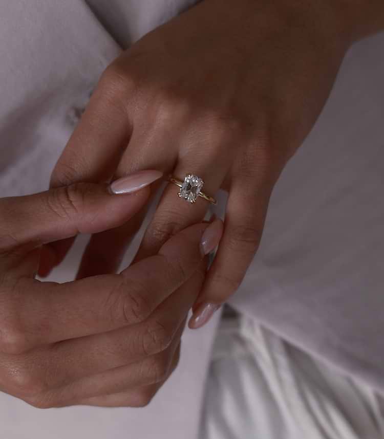 Hands with old mine cut diamond solitaire ring