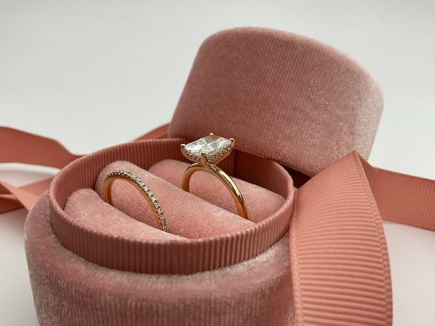 diamond engagement ring and matching wedding band in a pink velvet box