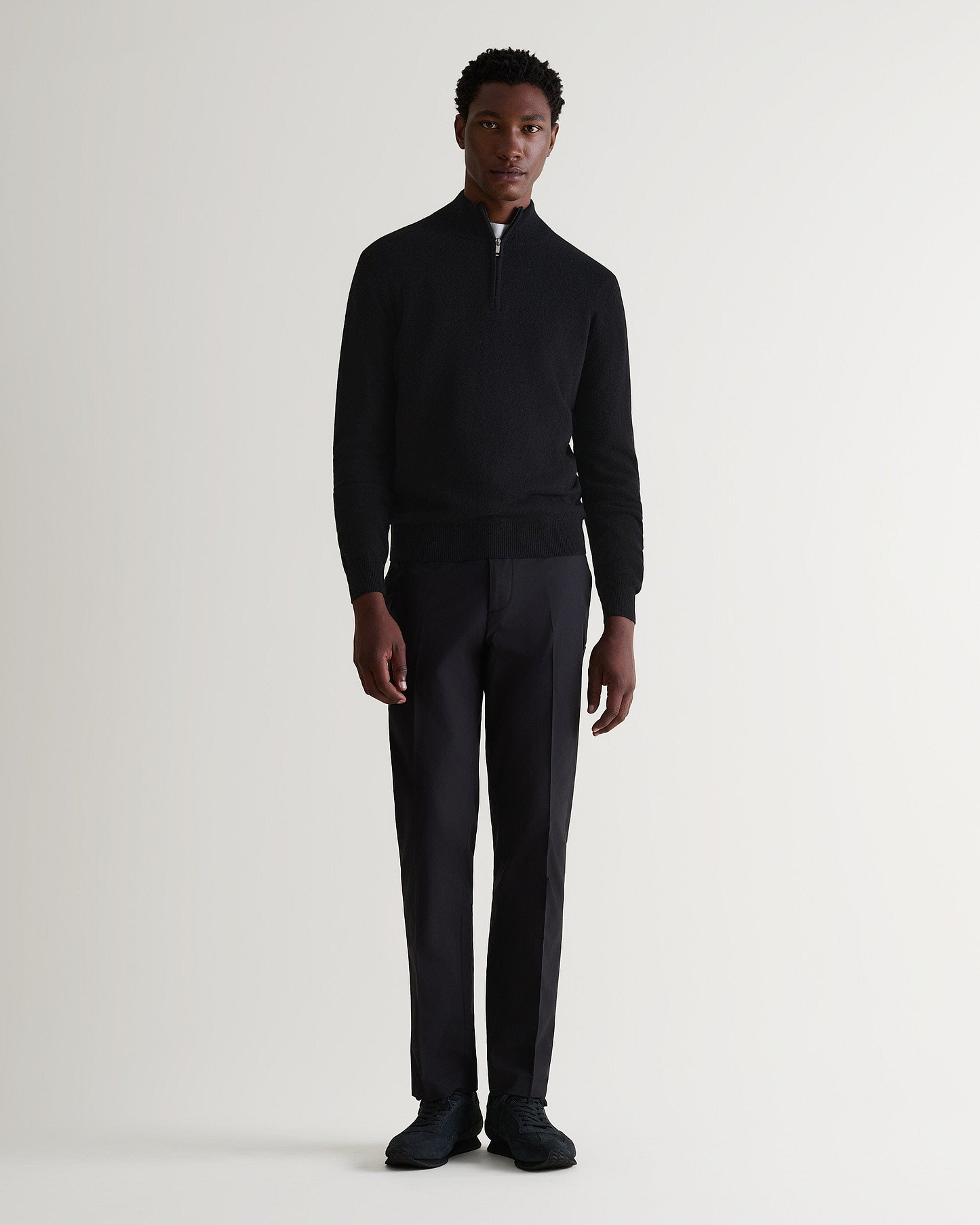 Image 1 of 5 showing man wearing Rise & Fall's fine cashmere 1/4 zip jumper, black