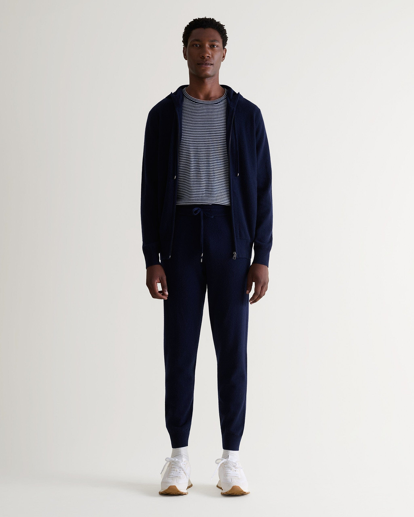 Image 1 of 5 showing man wearing Rise & Fall's fine cashmere jogger, navy.