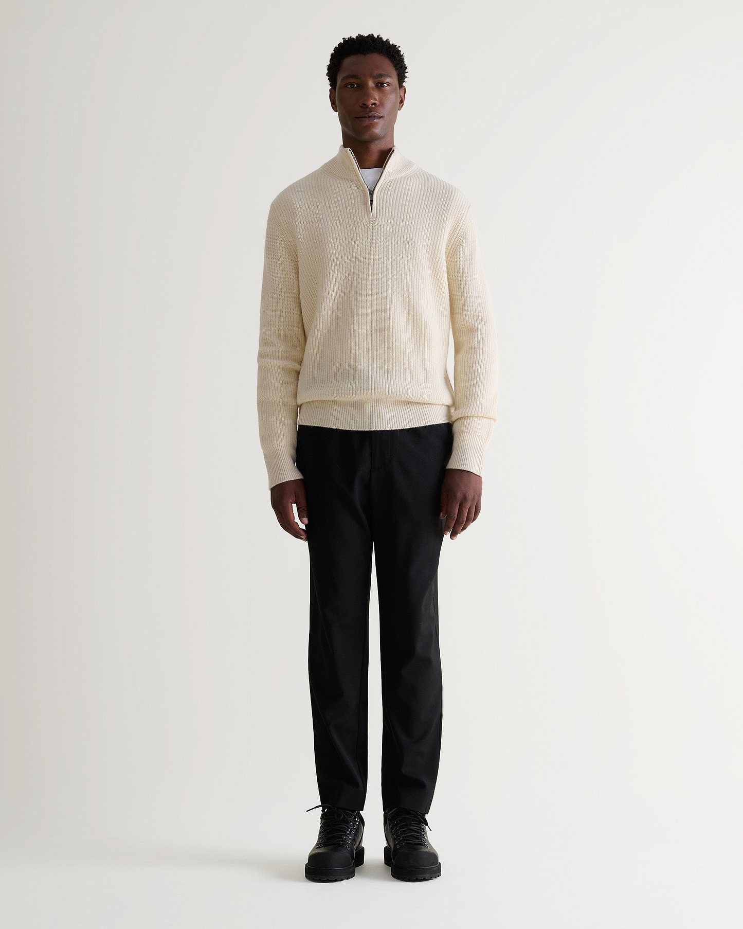 Image 1 of 6 showing man wearing Rise & Fall's Cashmere Merino Fishermans Rib 1/4 Zip Jumper in cream.