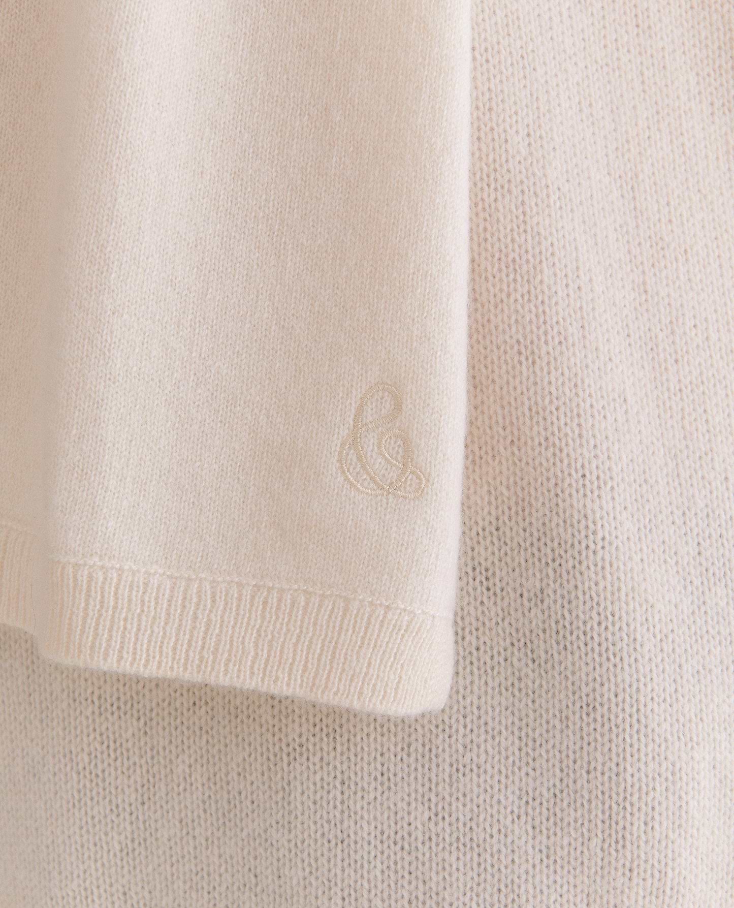 Image 2 of 2 showing close up of Rise & Fall's women's finest cashmere scarf in buttermilk cream with logo embelleshment.