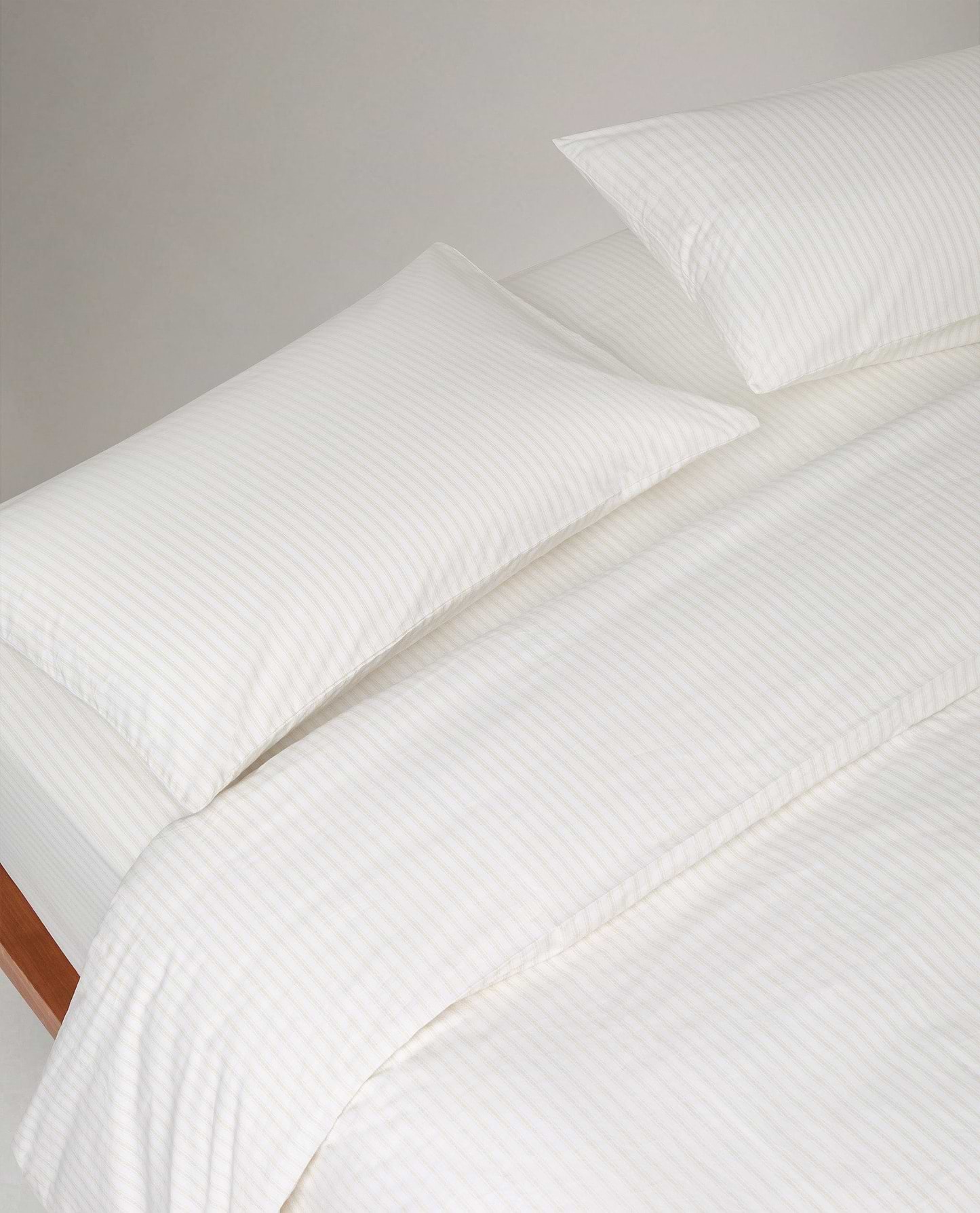 Image 2 of 3 showing Rise & Fall's Crisp & Cool Organic Cotton Pillowcases Set, colour: Buttermilk Ticking Stripe.