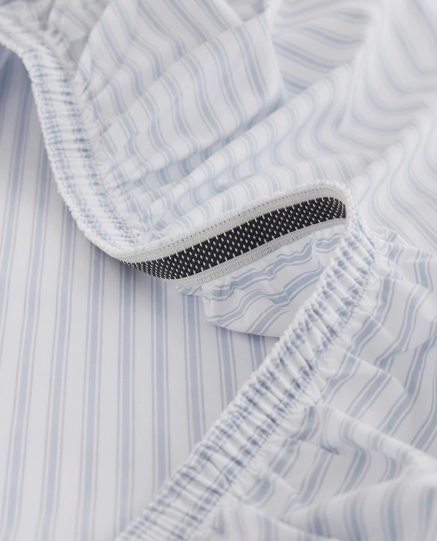 Image 2 of 6 showing Rise & Fall's Crisp & Cool organic cotton fitted bed sheet in blue stripe ticking.