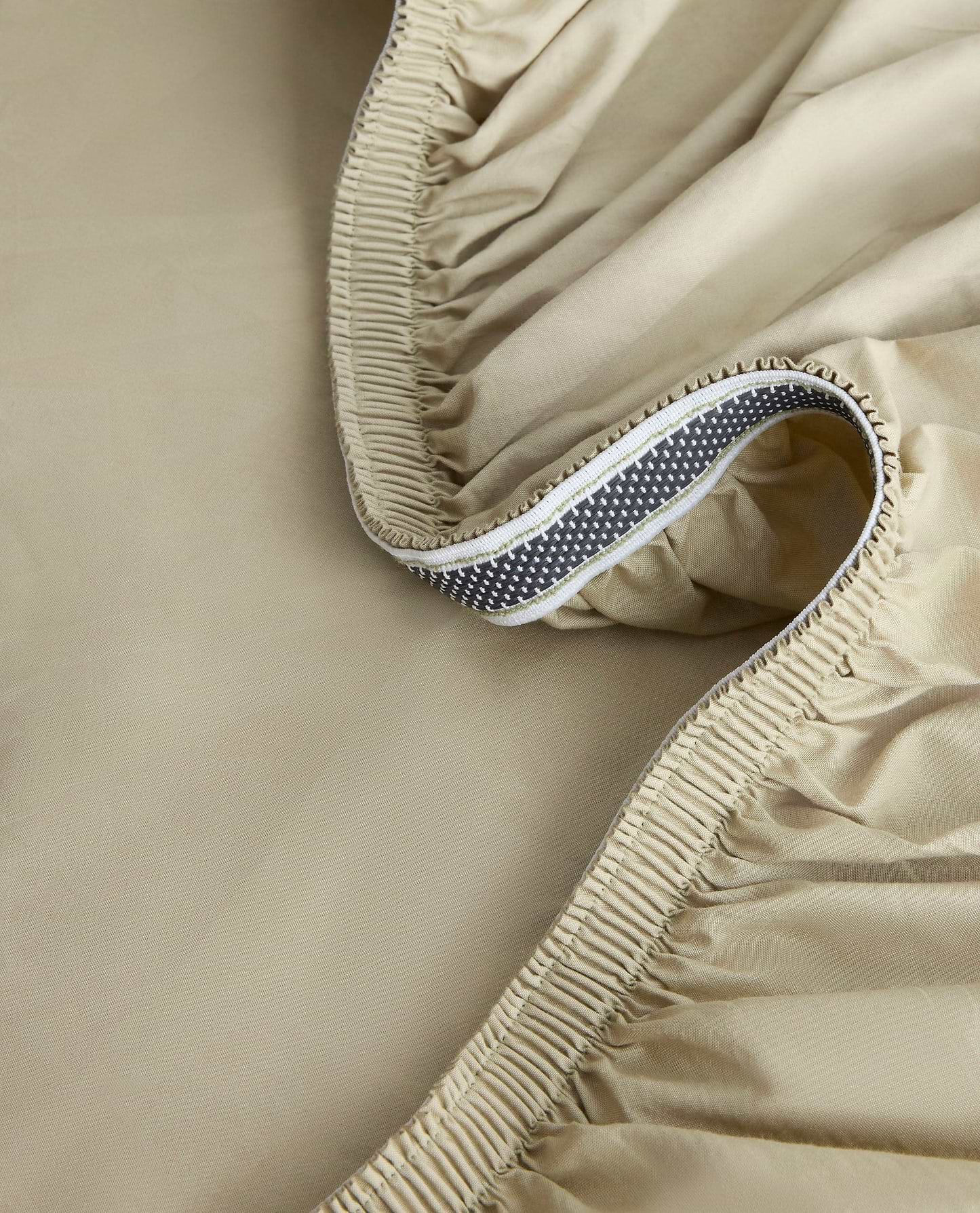 Image 2 of 6 showing close up of Rise & Fall's Crisp & Cool organic cotton fitted bed sheet in sage.