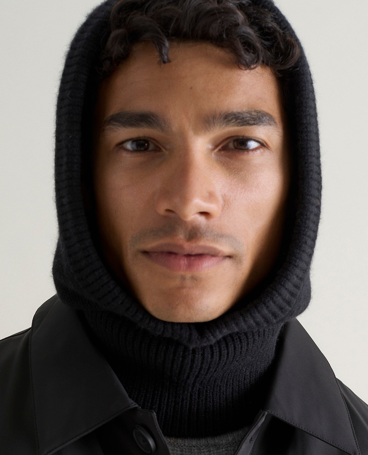 Image 3 of 4 showing man wearing Rise & Fall's black Cashmere Merino Knitted Hood.