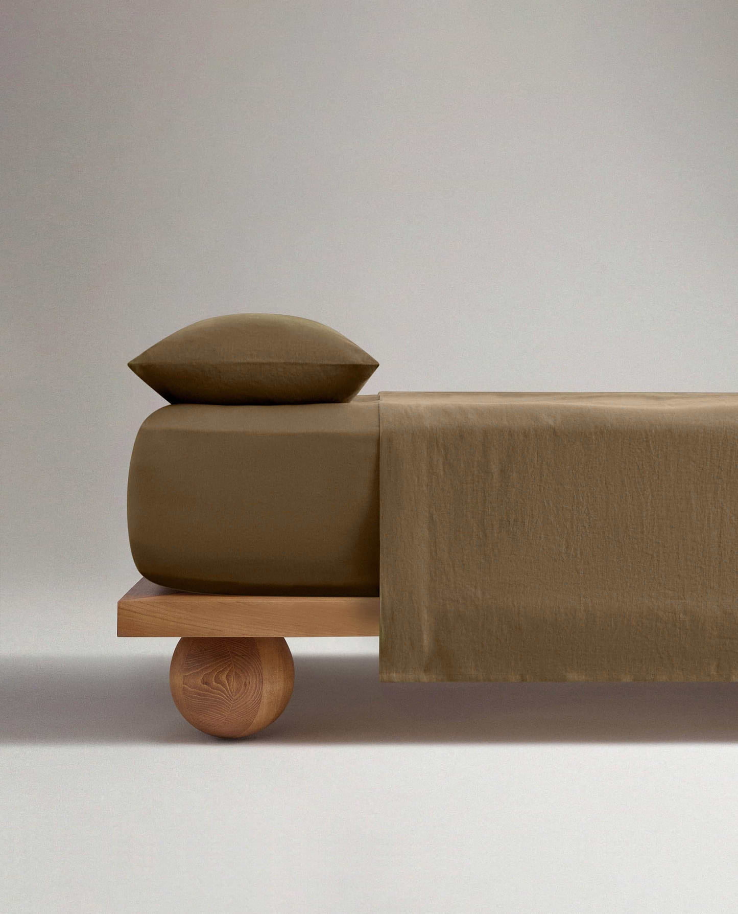 Image 3 of 4 showing Rise & Fall's Relaxed & Refined European flax™ linen fitted sheet in olive.