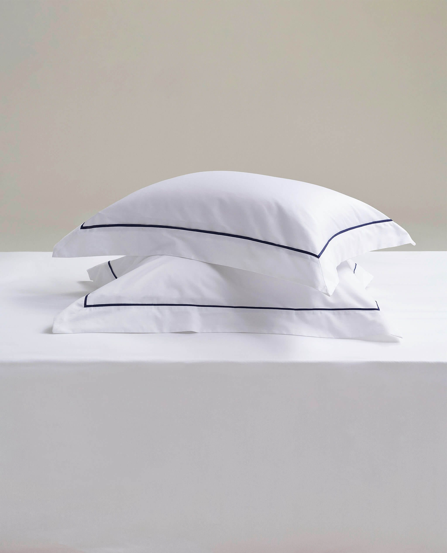 Image 3 of 4 showing Rise & Fall's Soft & Smooth Cotton Sateen Oxford Pillowcase Set in white navy piping.