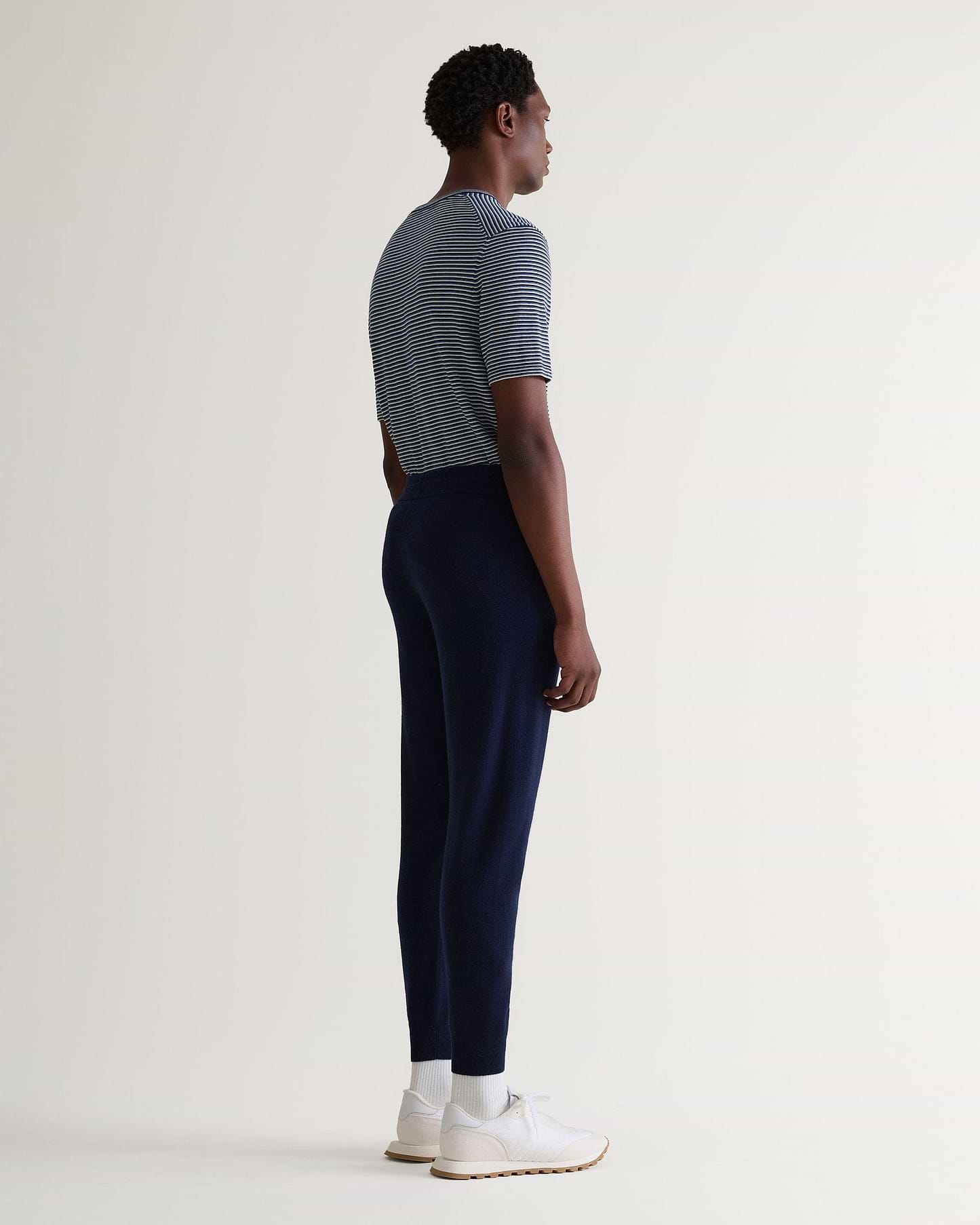 Image 3 of 5 showing man wearing Rise & Fall's fine cashmere jogger, navy.