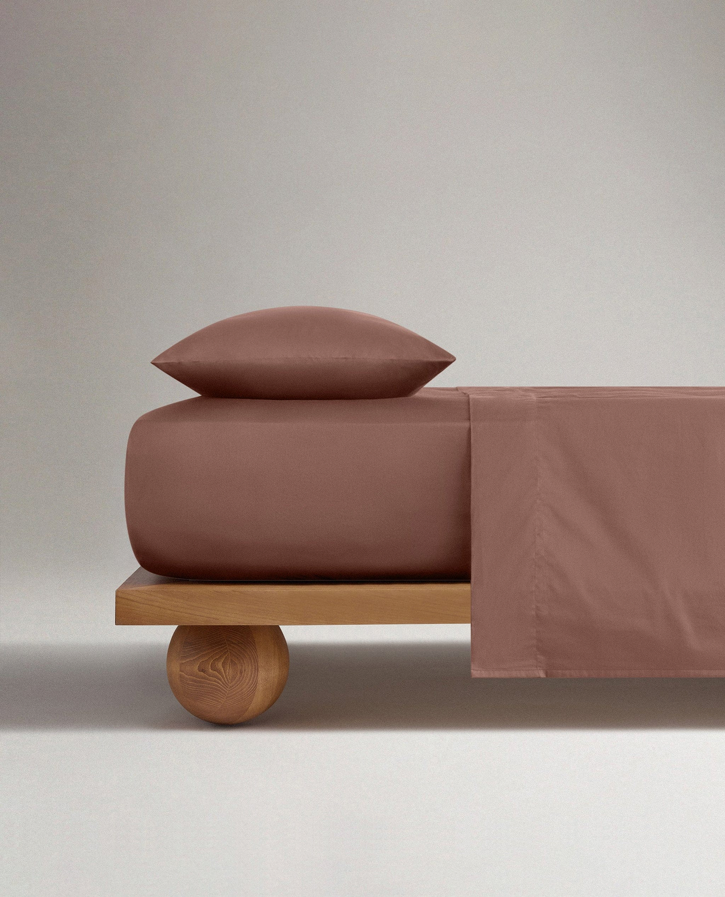 Image 3 of 5 showing Rise & Fall's Soft & Smooth sateen cotton deep fitted sheet in clay.