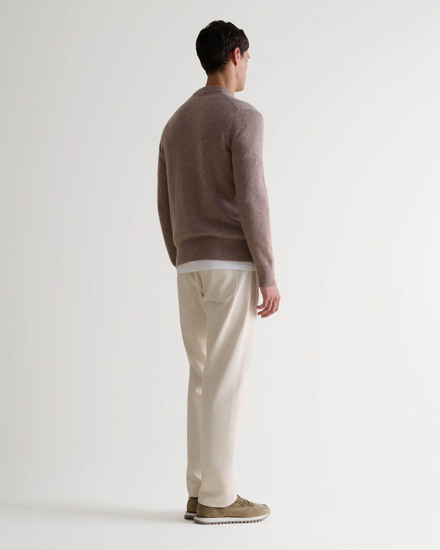Image 3 of 6 showing man wearing Rise & Fall's Finest Cashmere Mid-Weight Crew Neck Jumper in toast brown.