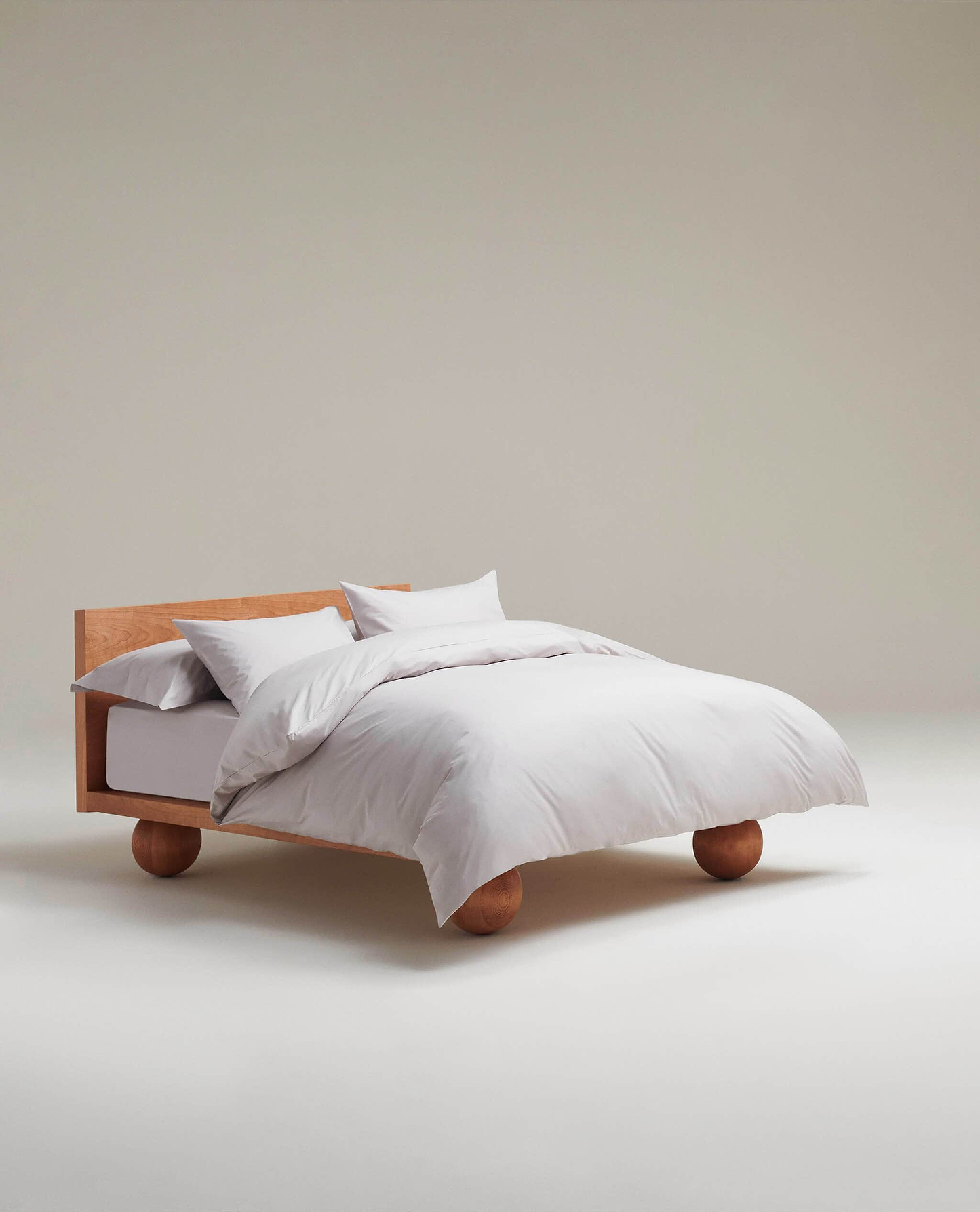 Image 4 of 4 showing a bed made with Rise & Fall's Crisp & Cool organic cotton flat sheet in pebble.