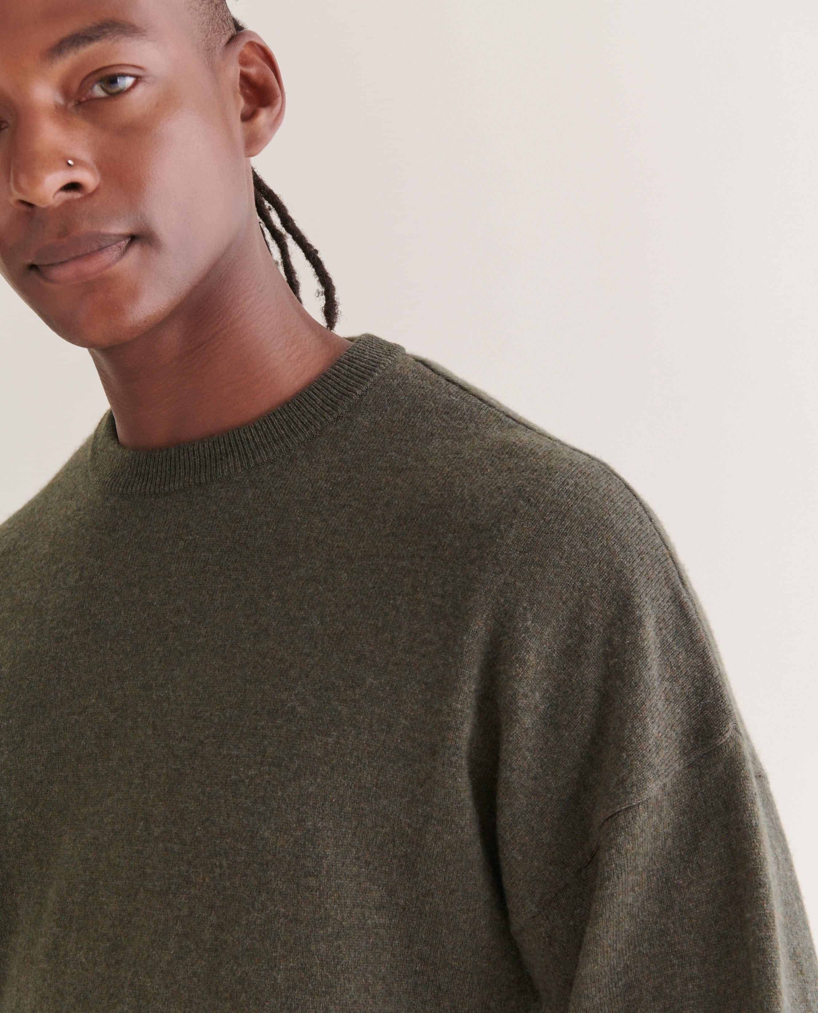 Image 4 of 5 showing man wearing Rise & Fall's finest cashmere mid-weight crew neck jumper in forest green.