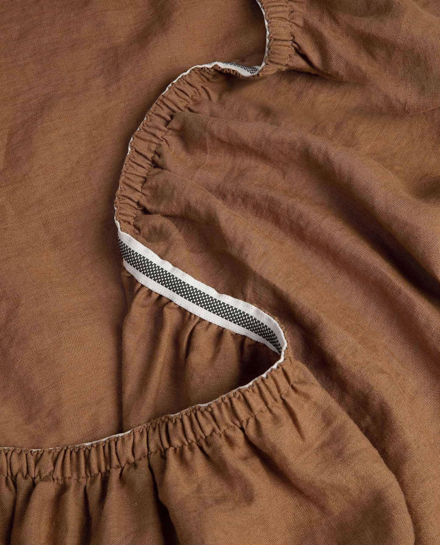 Image 4 of 5 showing Rise & Fall's Relaxed & Refined European flax™ linen fitted sheet in ochre.