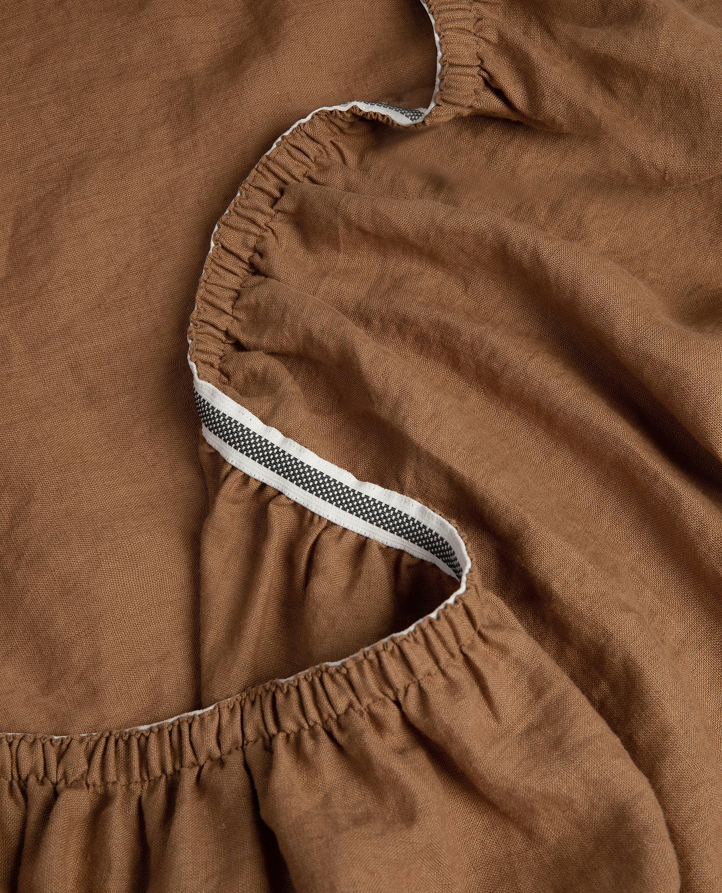 Image 4 of 5 showing Rise & Fall's Relaxed & Refined European flax™ linen fitted sheet in ochre.