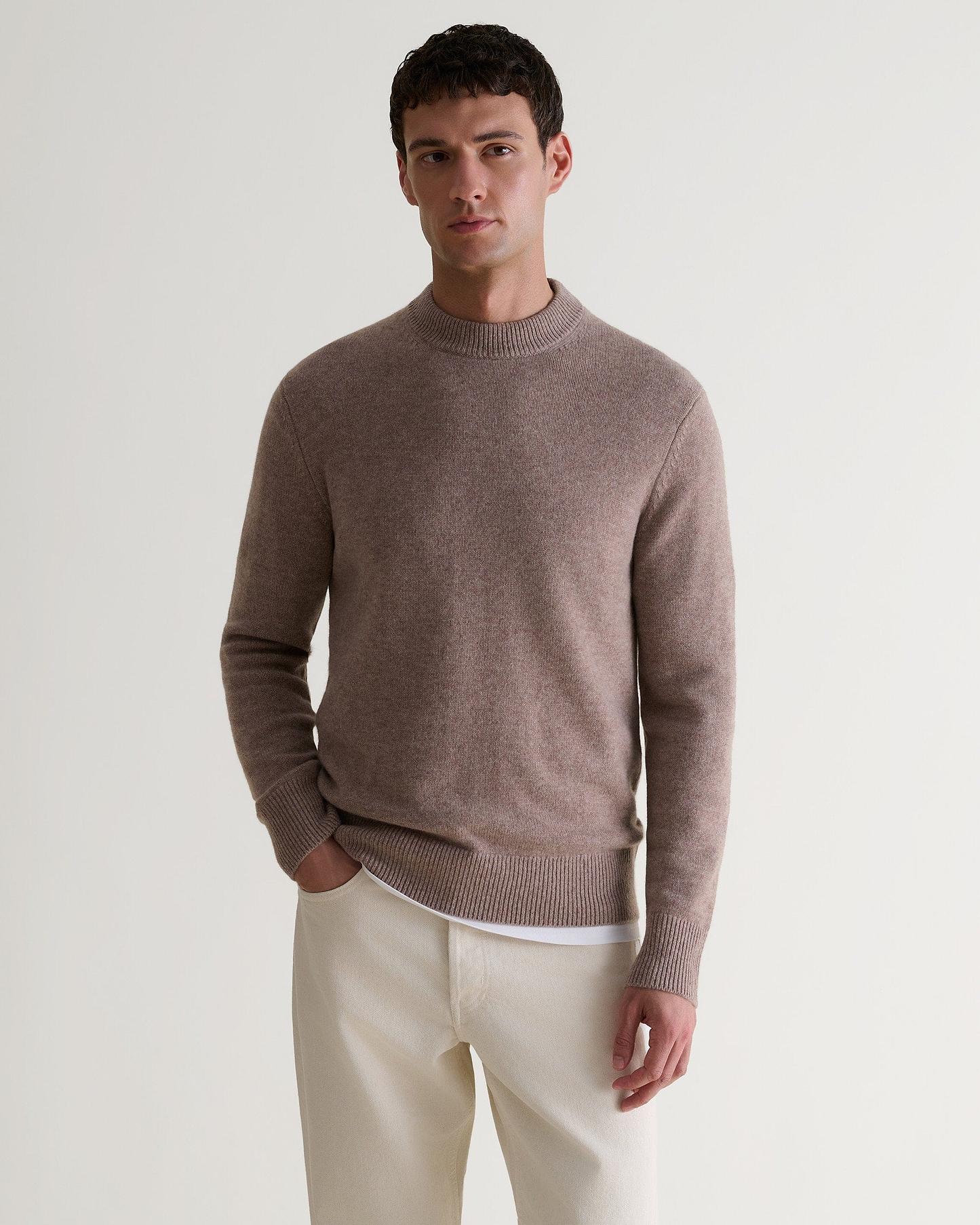 Image 4 of 6 showing man wearing Rise & Fall's Finest Cashmere Mid-Weight Crew Neck Jumper in toast brown.