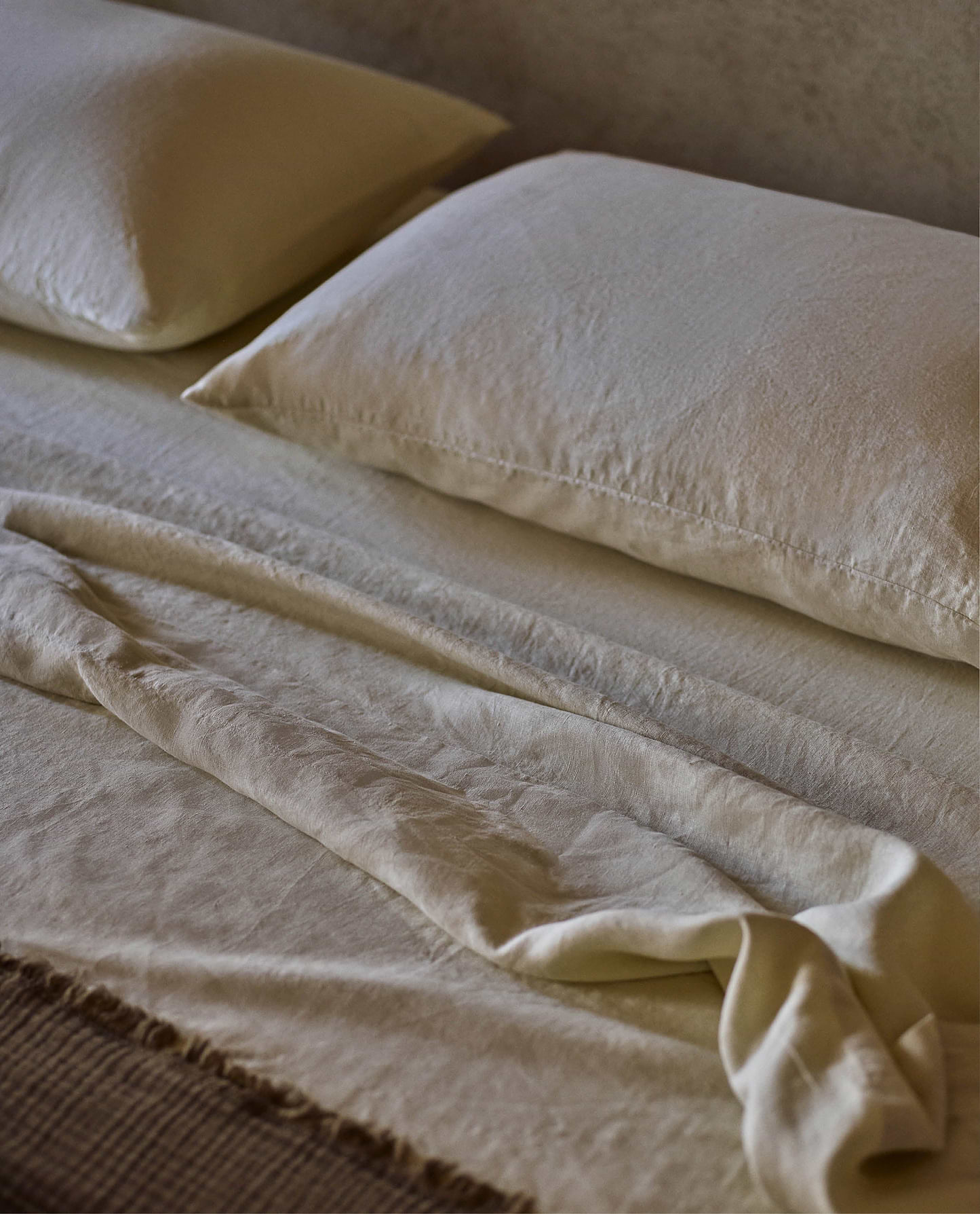 image 5 of 5 showing Rise & Fall's Relaxed & Refined linen duvet cover draped over wooden chair, fabric: European flax, colour: celery
