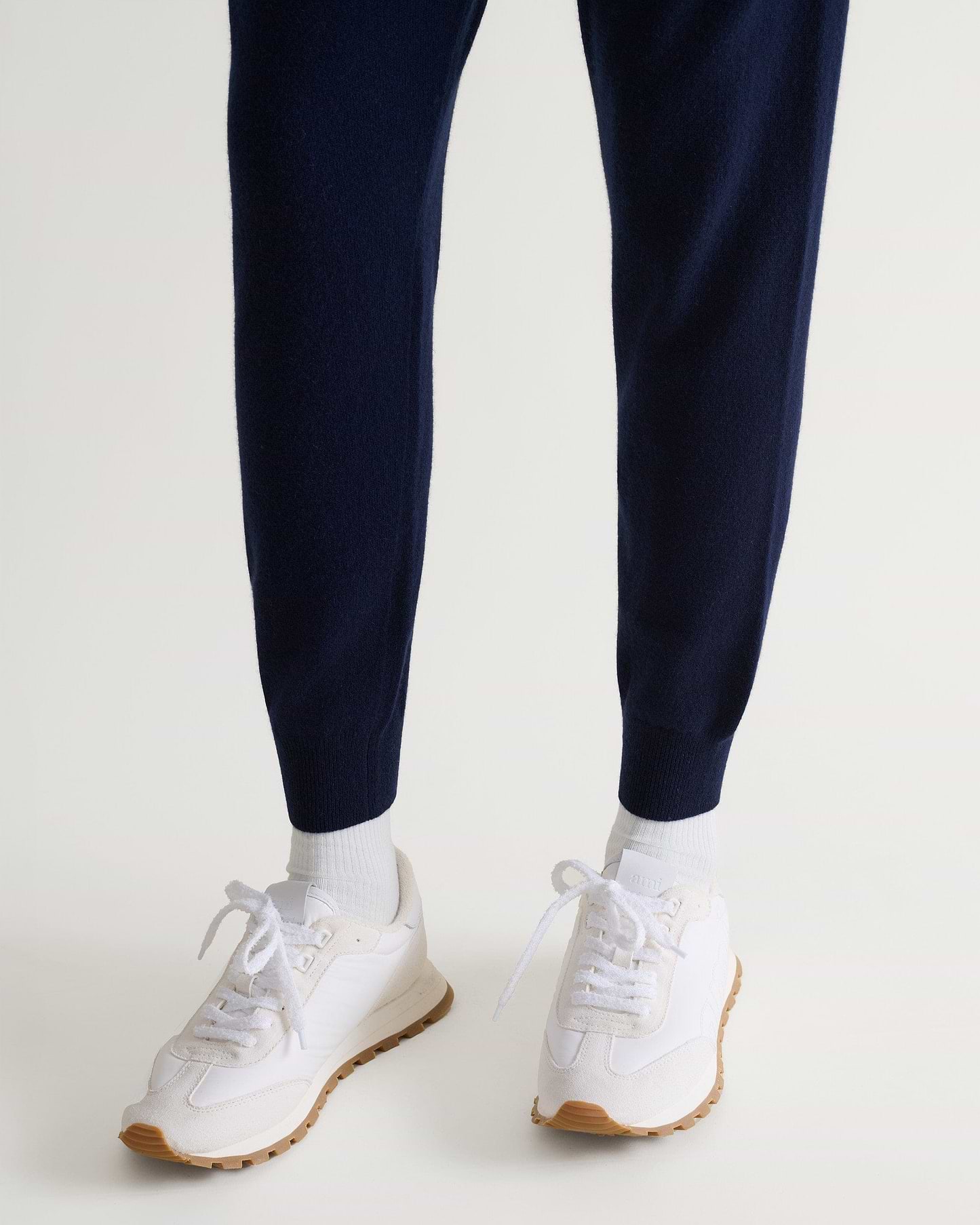 Image 5 of 5 showing man wearing Rise & Fall's fine cashmere joggers, navy, close-up.