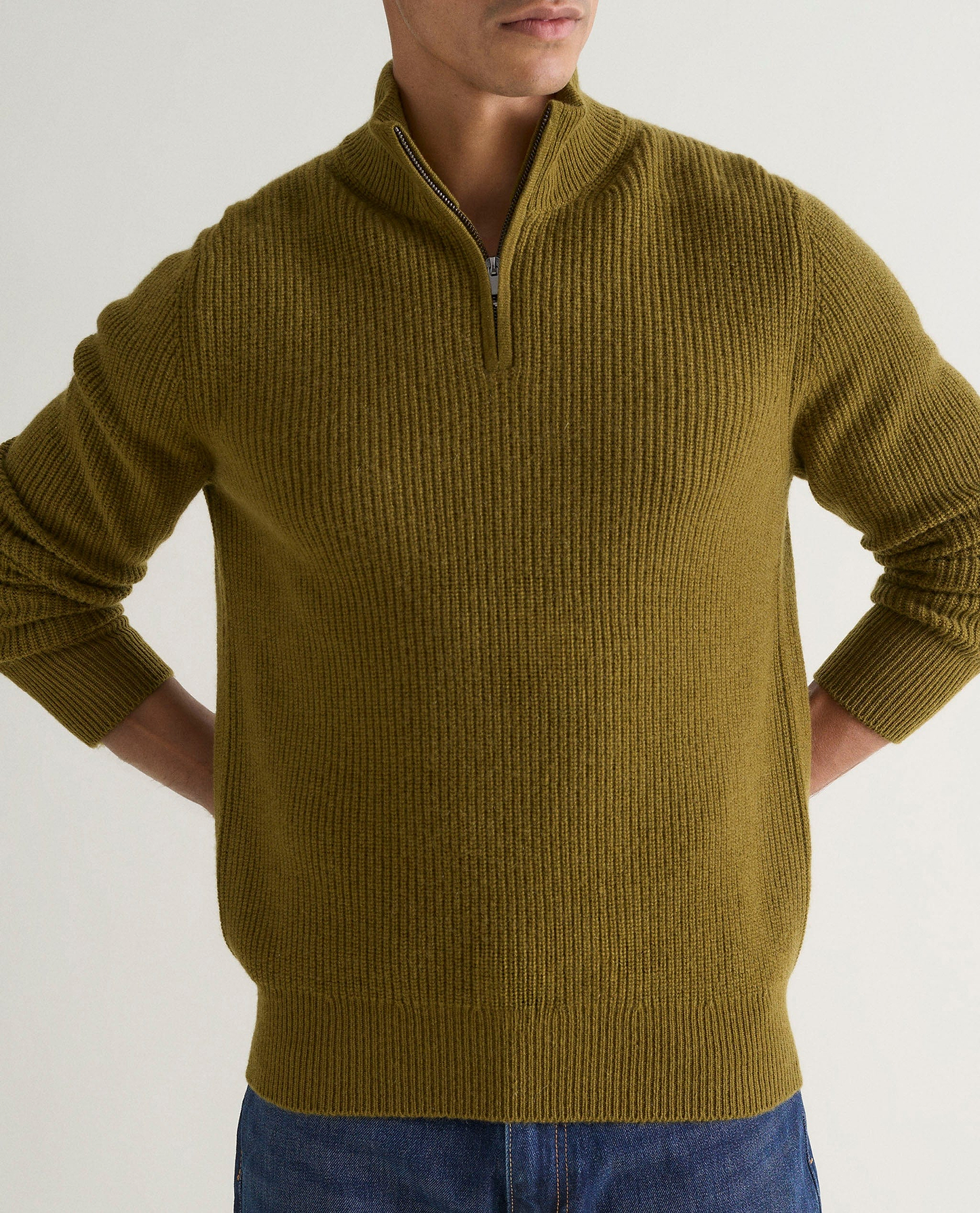 Image 5 of 6 showing man wearing Rise & Fall's Cashmere Merino Fishermans Rib 1/4 Zip Jumper in olive green.