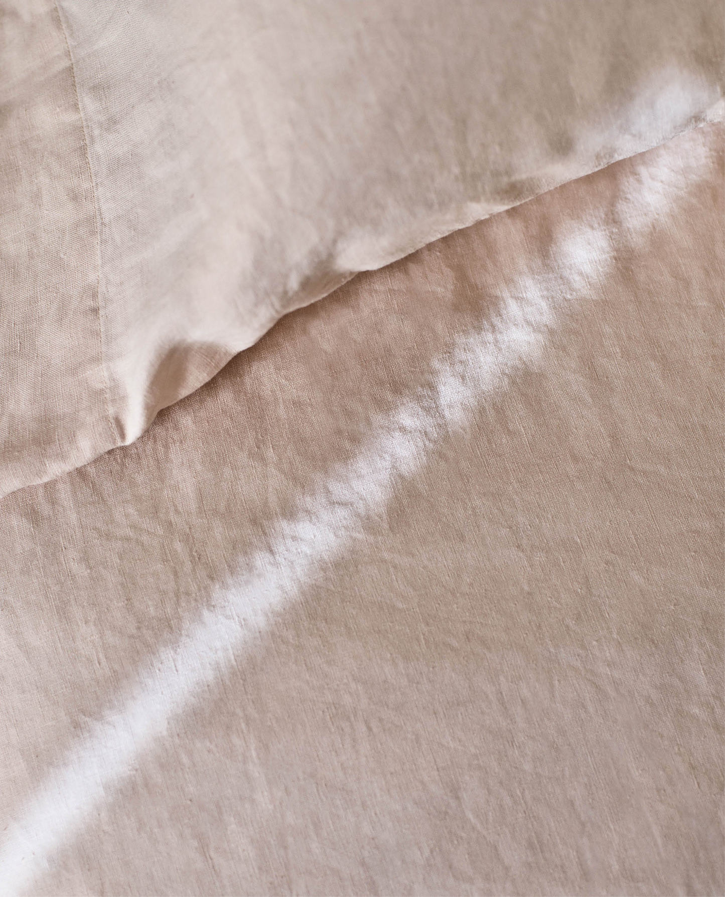 Image 5 of 6 showing Rise & Fall's House of Grey linen flat bed sheet in peach.