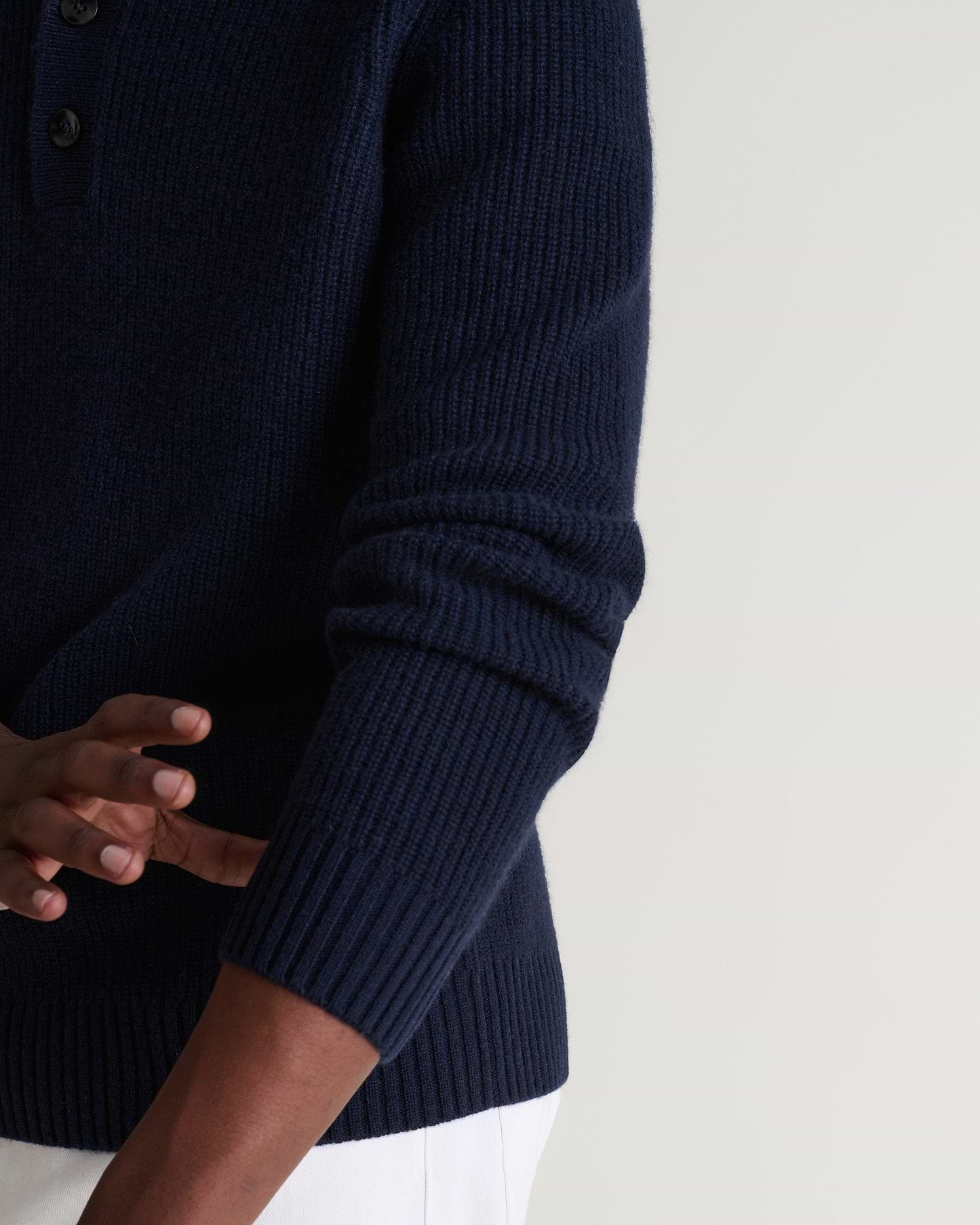 Image 6 of 6 showing man wearing Rise & Fall's indigio blue cashmere merino fisherman ribbed polo sweater. Close up of sleeve.