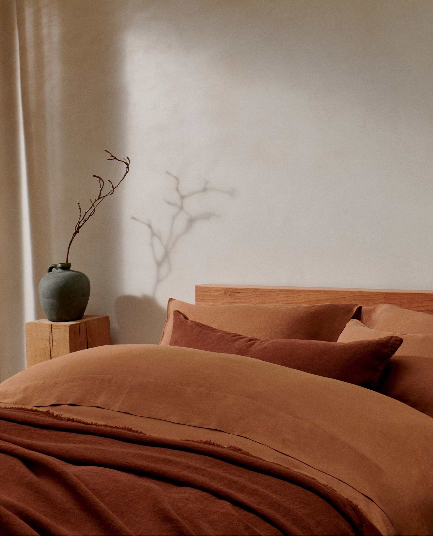 image 6 of 6 showing bed with Rise & Fall's Relaxed & Refined ochre linen duvet set with complementray linen throw and cushion