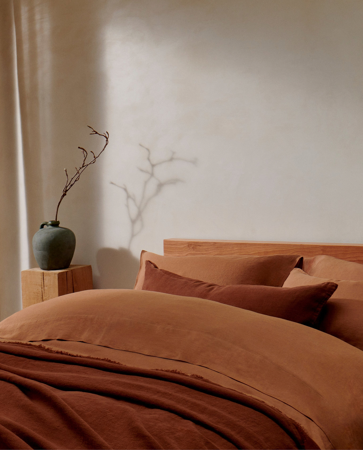 image 6 of 6 showing bed with Rise & Fall's Relaxed & Refined ochre linen duvet set with complementray linen throw and cushion
